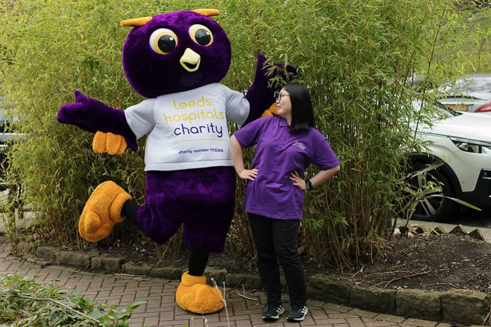 Leeds Hospitals Charity volunteer Yidan with charity mascot Ernie Owl