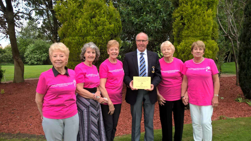 Members of Breast Cancer Research Action Group present President of Horsforth Golf Club with a plaque for fundraising efforts
