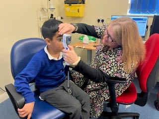 Azaan being examined using the tonometer by Specialist Optometrist Rachel Bond