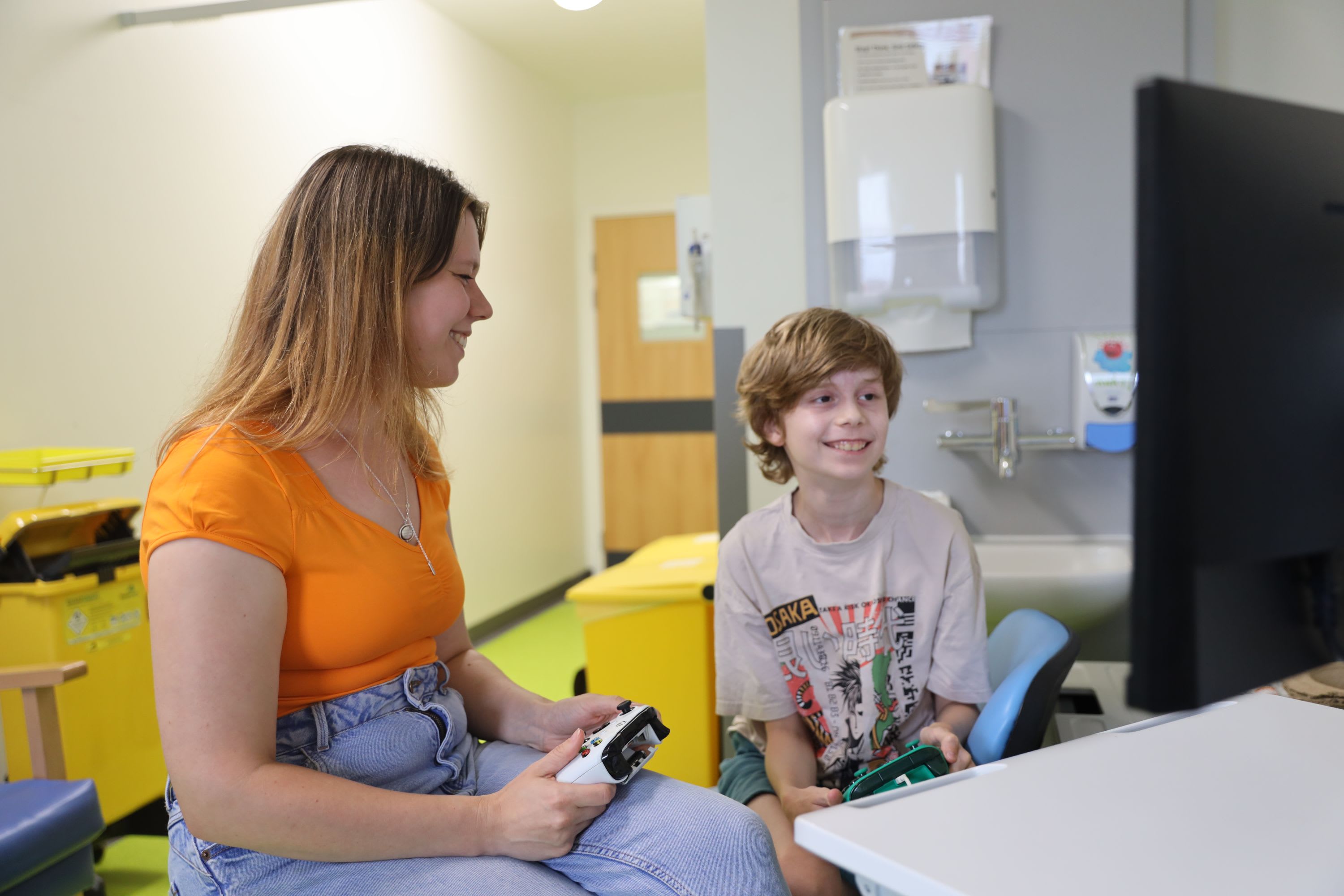 Max playing a video game at Leeds Childrens Hospital with his mum Laura