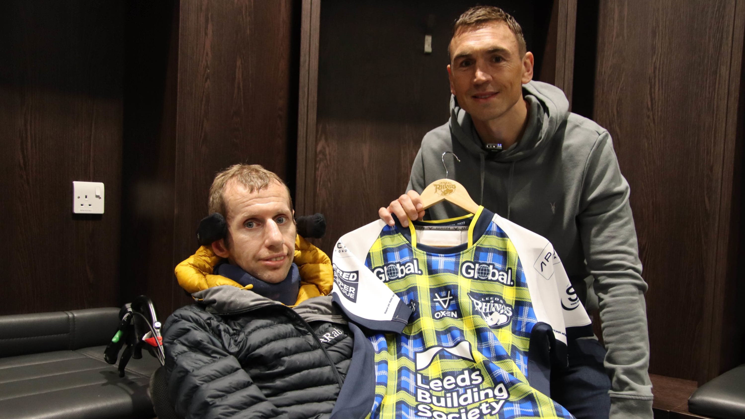 Rob Burrow and Kevin Sinfield holding a running shirt with My Name5 Doddie tartan