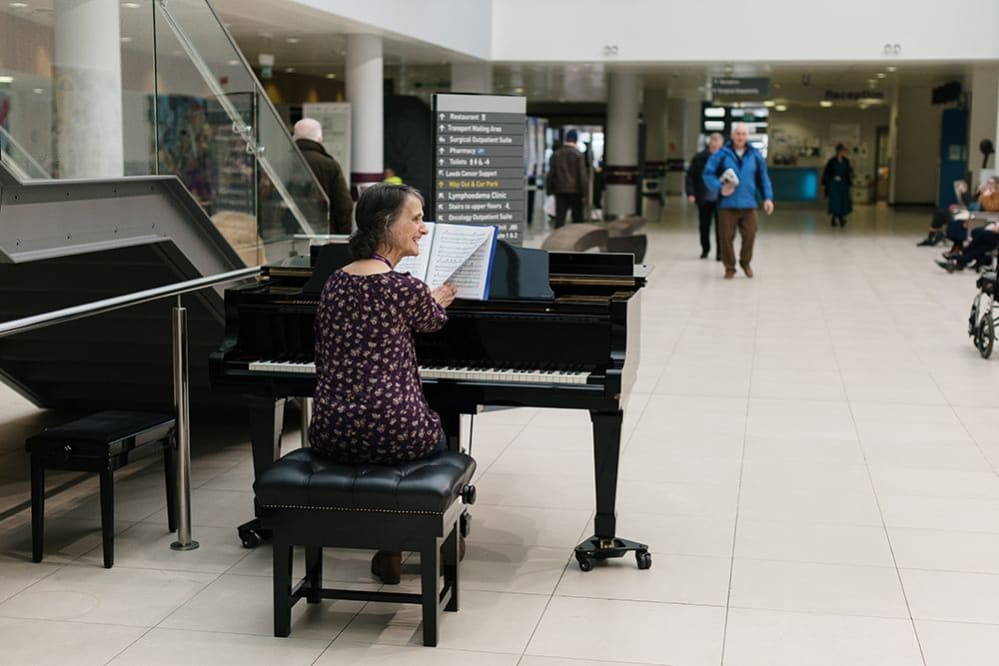 Leeds Hospitals Charity volunteer pianist Sue performs in the Bexley Wing Atrium at Leeds Cancer Centre
