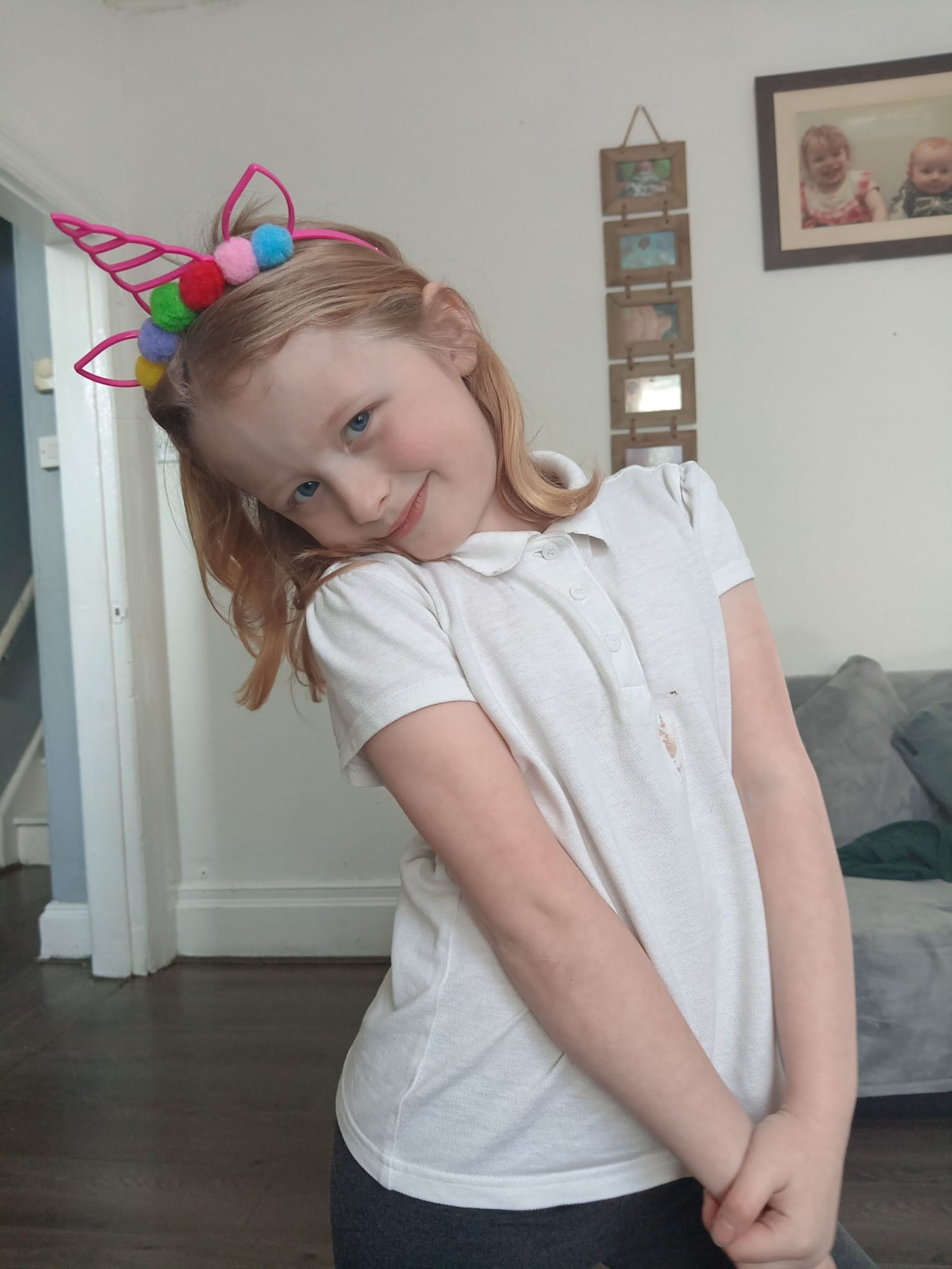 Freya at home wearing a unicorn headband after successful surgery