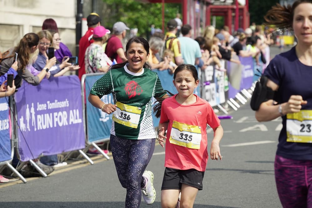 A mother and daughter enjoying the Leeds Mini & Junior Run in 2023
