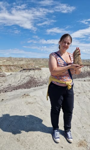Leila Rittey holding dinosaur bones in Canada
