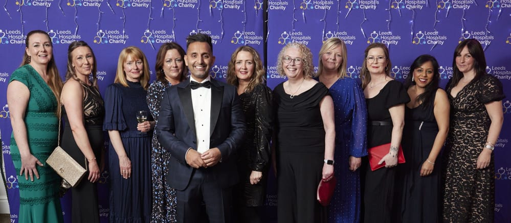 group of women stood with Dr Amir Khan at the charity ball event