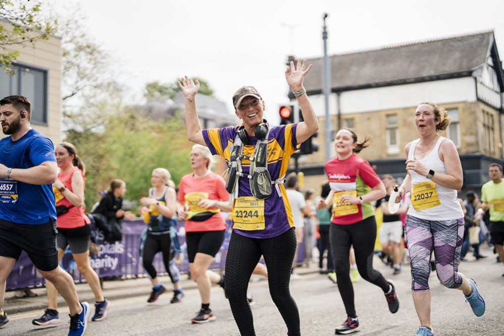A female runner taking part in the 2023 Leeds Half Marathon, supporting Leeds Hospitals Charity