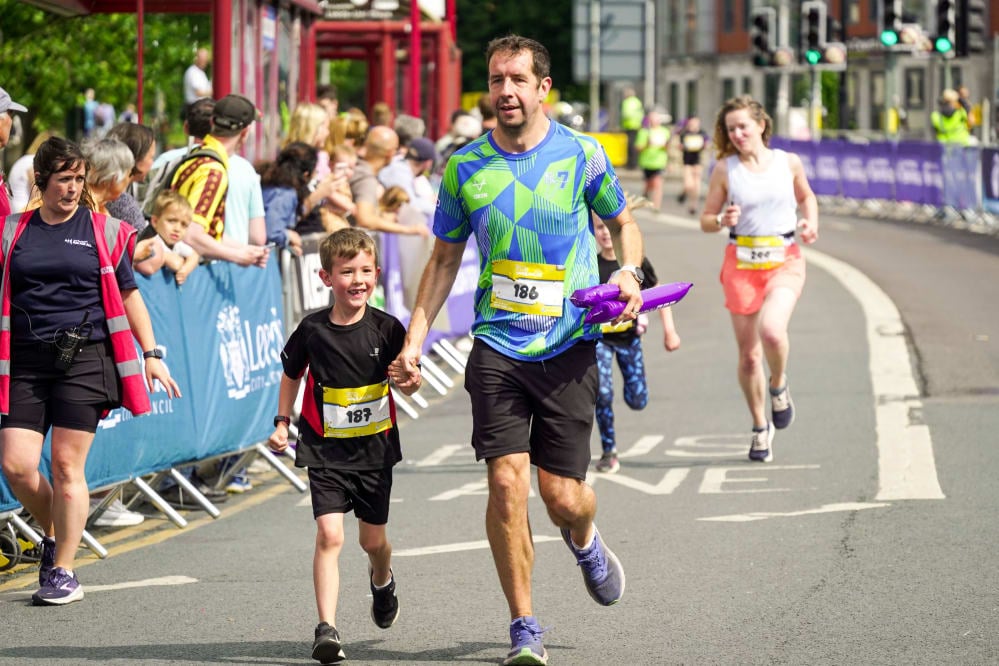 A father and son running in the Leeds Mini & Junior Run 2023